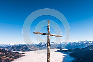 Christian cross over the top of mountain range