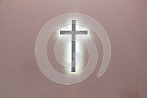 Christian cross on a pink background. a symbol of Christianity. crucifixion