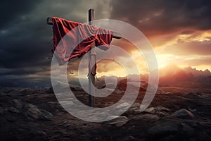 A christian cross with a red cloth, on top of the mountain against sunset light and cloudy sky in a dramatic scenery. Fosus on the