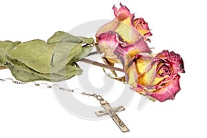 Christian cross on rosary and a yellow red rose isolated on white