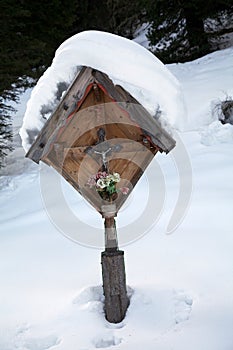 Christian cross among the snow