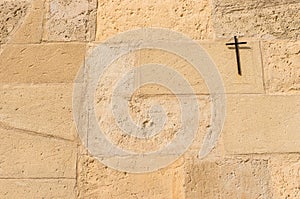 Christian cross on stone wall background with religious symbol