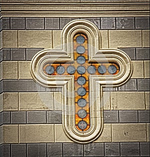 Christian cross on stone wall of old church