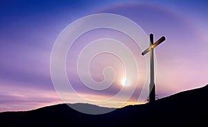 Christian cross at sunrise or sunset concept of religion