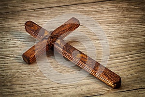 Christian Cross - symbol of the Christian faith, the main attribute of Christians. Handmade wooden cross on wooden background