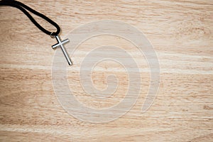 Christian cross on wood background