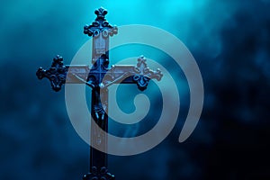 A Christian crucifix, the cross is in a misty ethereal Gothic atmosphere of mist and ghostly dark blue darkness