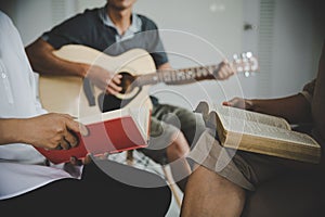 Christian family groups praying with Holy Bible