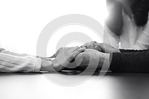 Christian family holding hands, praying and worshiping together background