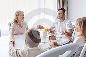 christian family praying before breakfast