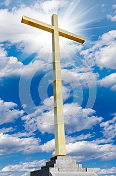 Christian gold cross on sky. Religion and faith concept.