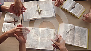 Christian group praying together with bible. Burgeoning