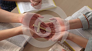 Christian group praying together with bible. Burgeoning