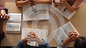 Christian group praying together with bible. Burgeoning