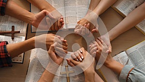 Christian group praying together with bible. Burgeoning