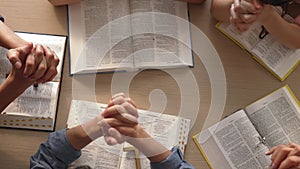 Christian group praying together with bible. Burgeoning
