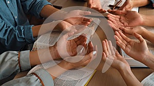 Christian group praying together with bible. Burgeoning