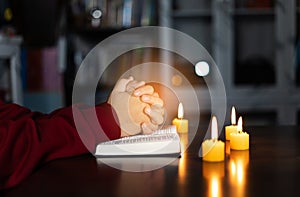 Christian hand while praying and worship for christian religion with blurred of her body background,