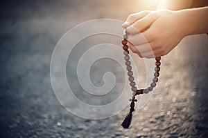 The Christian holds in his hands wooden rosaries