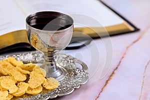 Christian Holy Communion with unleavened bread, wine, chalice, and symbols of Christ the Savior