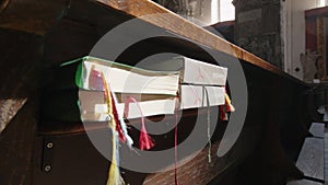 christian hymn books in church pew