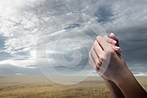 Christian man praying with raised hands