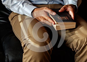 Christian man is sitting and opening a Bible. In order to pray before Jesus remember His goodness. Concept wish faith reading