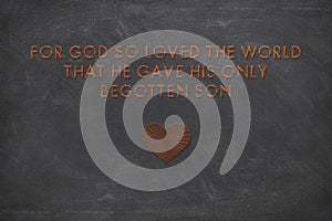 Christian Motivational quote saying For God so loved the world that he gave his only begotten Son on rough black background stock photo