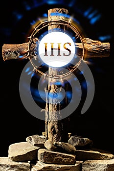 A Christian old wooden crucifix with a crown of thorns and a symbol of Christ.