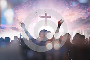 Christian people group raise hands up worship God Jesus Christ together on cross over cloudy sky background