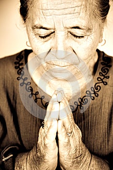 Christian senior woman praying to God