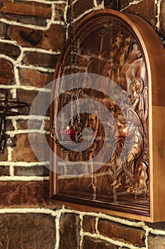 Three-dimensional icon on a Christian theme carved from wood photo