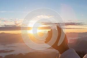 Christian woman hands praying to god on the mountain background with morning sunrise. Woman Pray for god blessing to wishing have