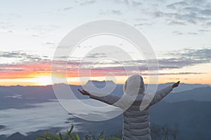 Christian woman hands praying to god on the mountain background with morning sunrise. Woman Pray for god blessing to wishing have
