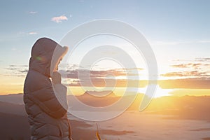 Christian woman hands praying to god on the mountain background with morning sunrise. Woman Pray for god blessing to wishing have