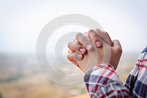 Christian woman  hands praying to god on the mountain background with morning sunrise. Woman Pray for god blessing to wishing have