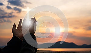 Christian woman praying worship at sunset. Hands folded in prayer. worship god with christian concept religion.