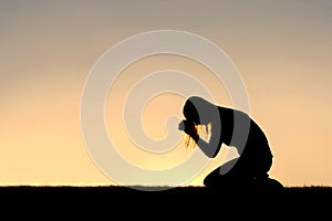 Christian Woman Sitting Down in Prayer Silhouette