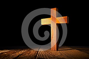Christian wood cross on black background