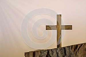 Christian wooden cross on a gradient background with dramatic lighting