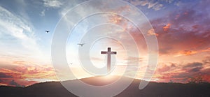 Christian wooden cross on the mountain  sunset background