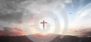 Christian wooden cross on the mountain  sunset background