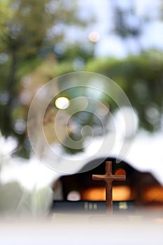 Christian worshiping and praying, with bible and cross of Jesus Christ