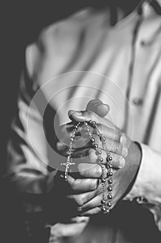 Christianity background of man hand holding rosary praying for god blessing