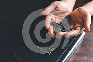 Christianity woman catholic hand holding cross crucifix pray to god, person prayer in church concept of religion, spirituality,