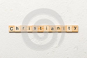 christianity word written on wood block. christianity text on table, concept
