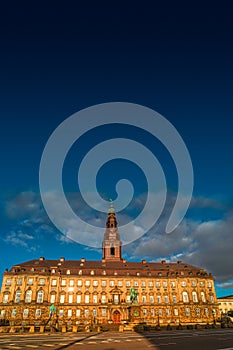 Christiansborg Palace illuminated by sunrise in early morning, Copenhagen, Denmark, summer time, paste space