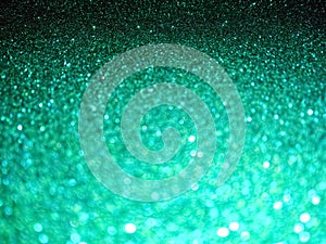 Christmas abstract background. Defocused lights texture. Abstract bokeh lights. Shiny sparkle emerald metallic glitter texture.