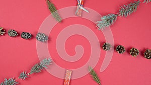 Christmas abstract pattern 360 degree rotation. Fir tree branches, gift box and cone spinning on red background.