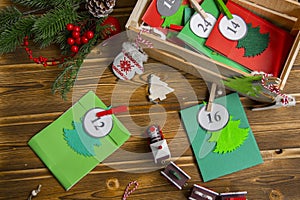 Christmas Advent calendar on the table, in a wooden box. Multicolored envelopes made by hand photo